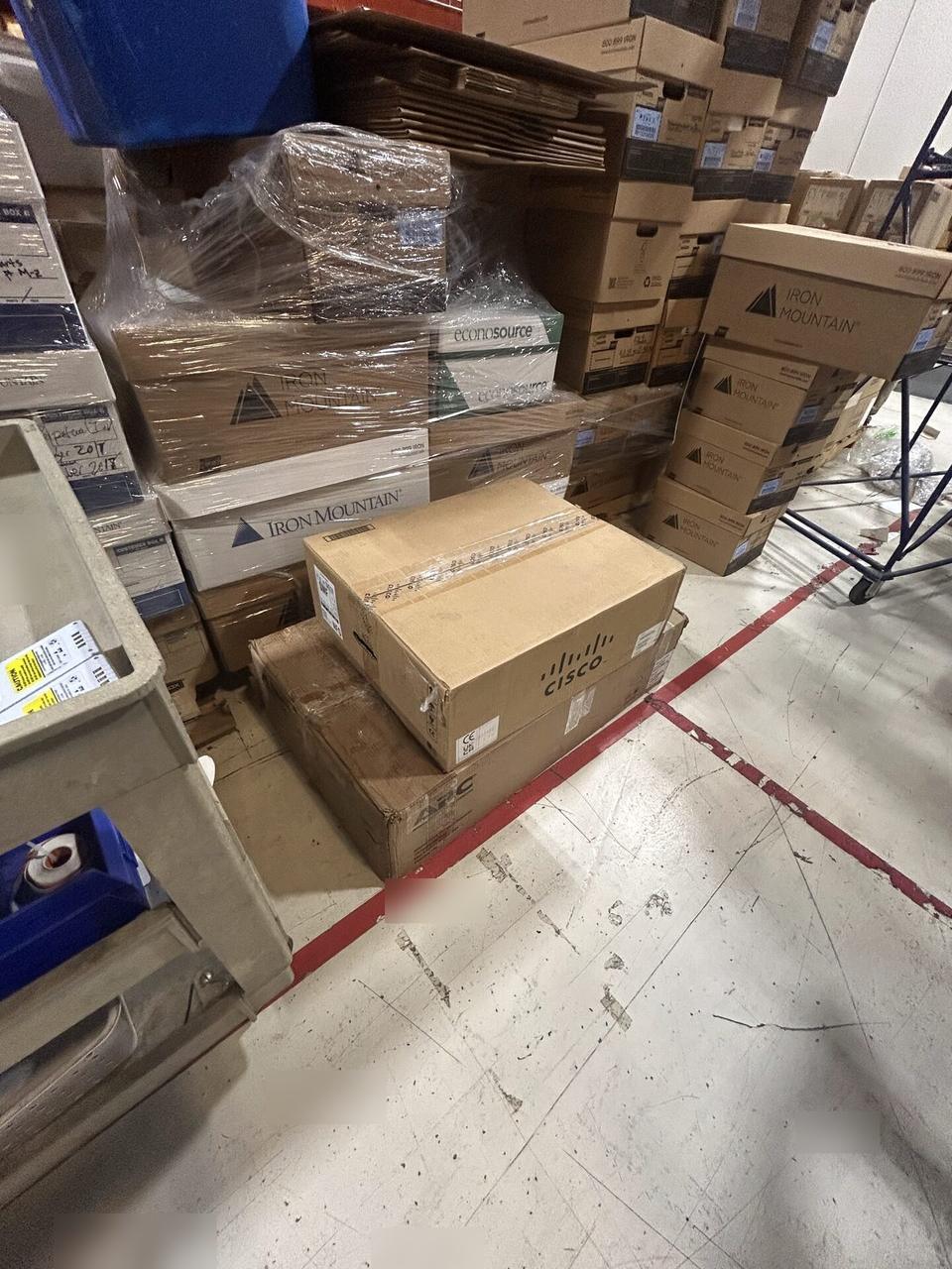 Onsite service photo showing rack-mounted network hardware during service with rack cabling organized