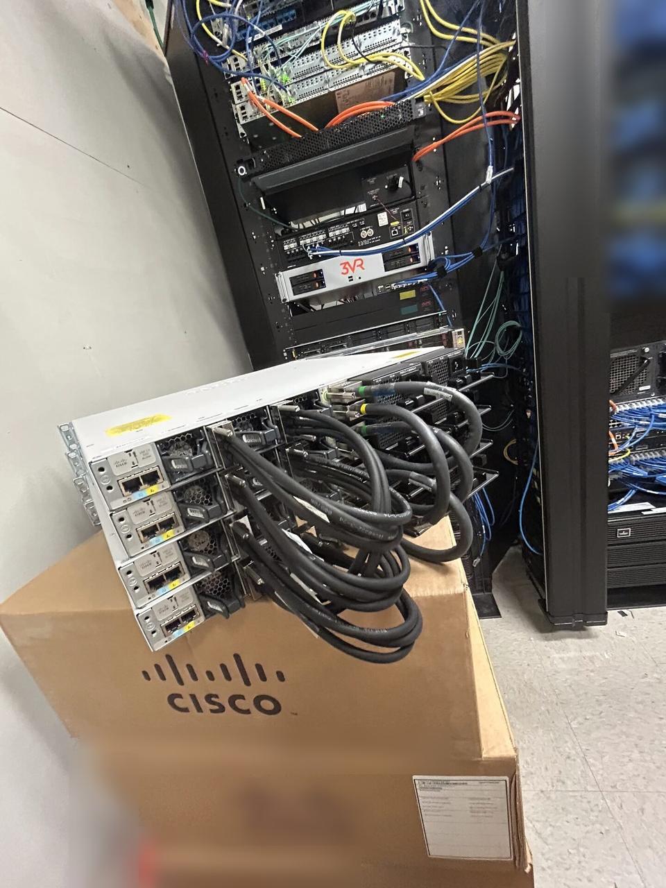 Service documentation showing rack-mounted network hardware during service at the server-room handoff point