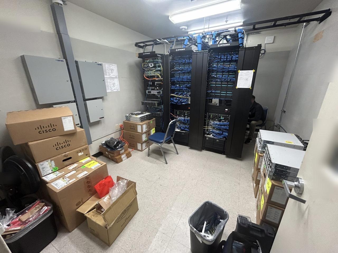 Service documentation showing rack-mounted network hardware during service with rack cabling organized