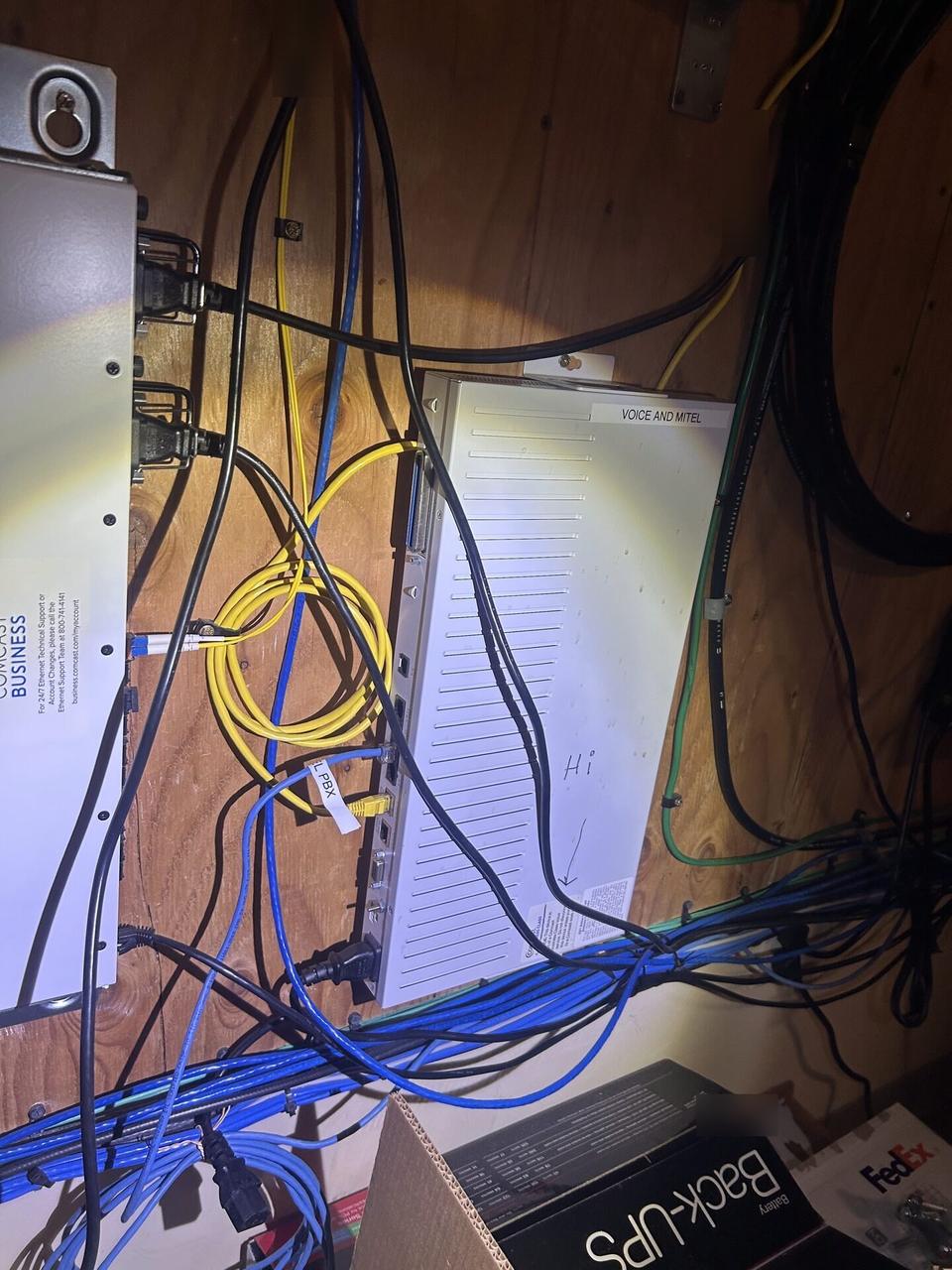 Service documentation showing equipment cabinet cabling and switch handoff with private labels omitted