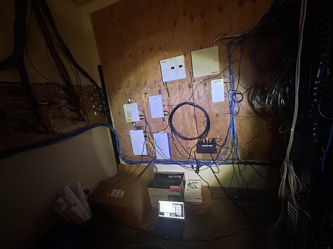 Public-safe portfolio image of equipment cabinet cabling and switch handoff with structured cabling visible