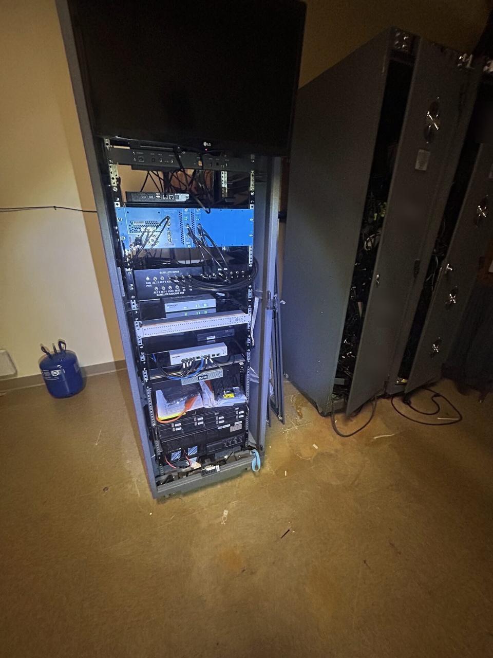 Server-room cabinet and structured network equipment with private labels omitted during an Alrty onsite service visit