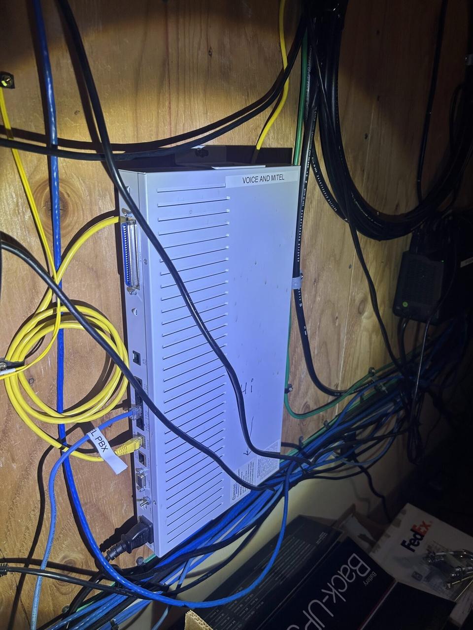 Public-safe portfolio image of structured cabling inside a network rack during network hardware support