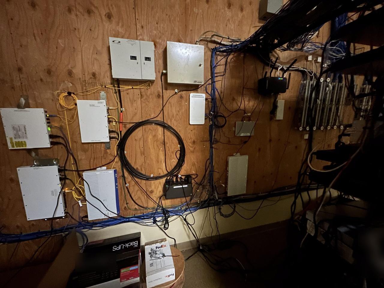 Public-safe portfolio image of equipment cabinet cabling and switch handoff during switch or patch-panel service