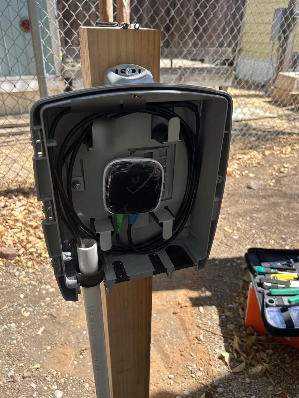 Outdoor fiber-to-Cat6 cabling route documented for a smart technology service call