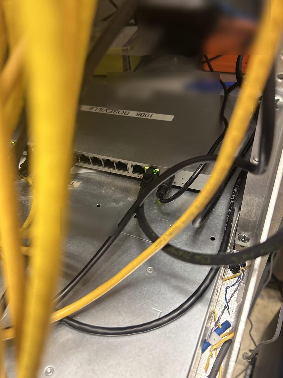 Alrty field photo with rack-mounted network hardware during service with rack cabling organized