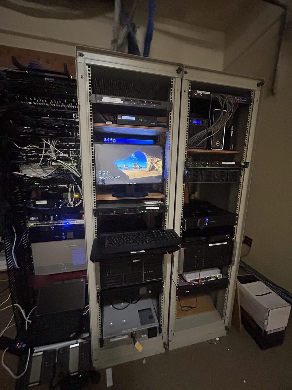 Server-room cabinet and structured network equipment before final connectivity checks documented for a smart technology service call