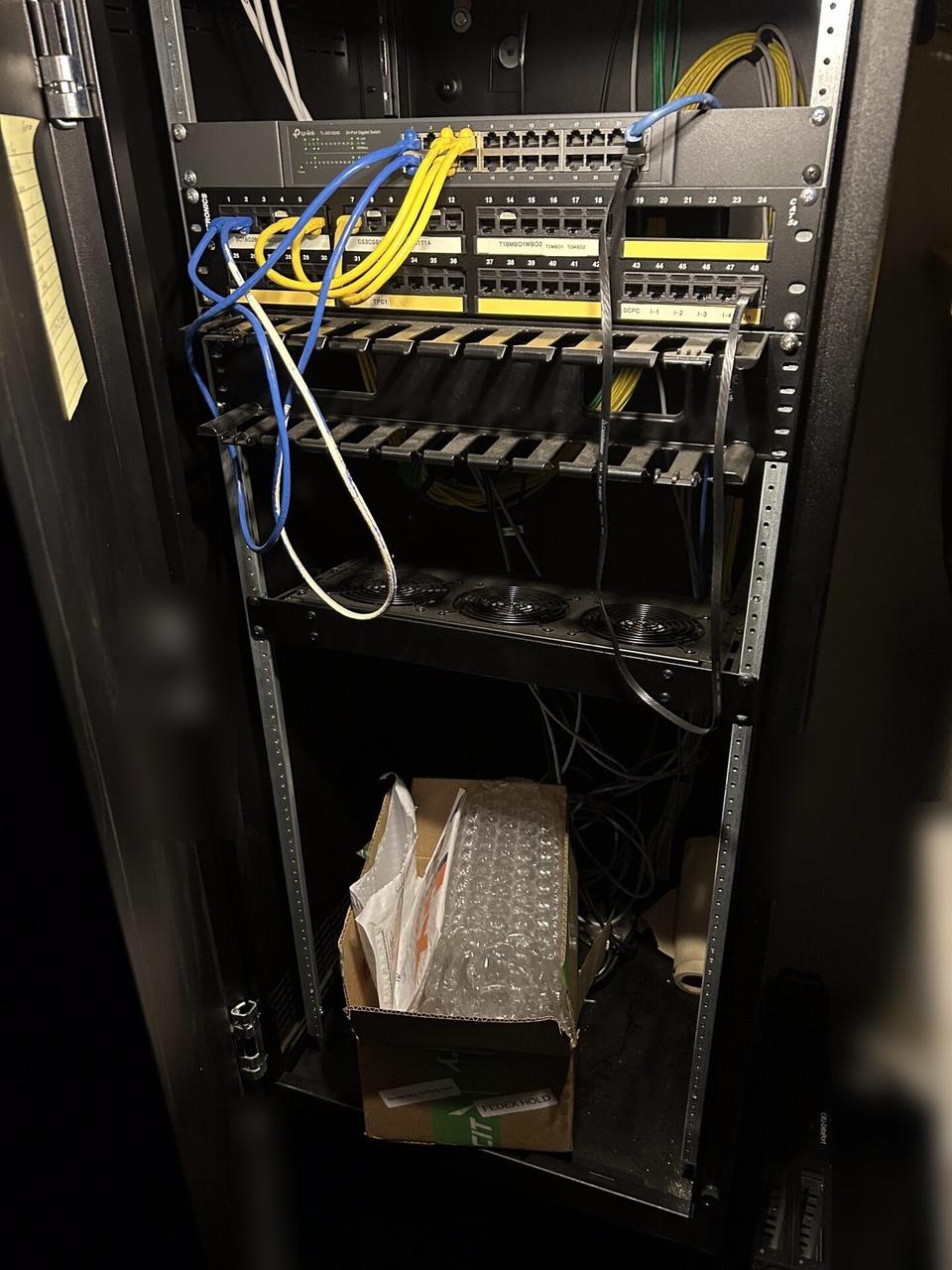 Public-safe portfolio image of server-room cabinet and structured network equipment inside the equipment cabinet