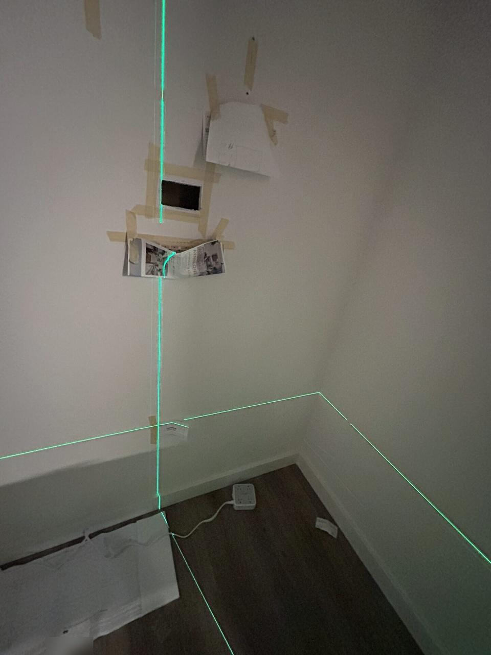 Close view of drywall opening prepared for in-wall TV cable routing