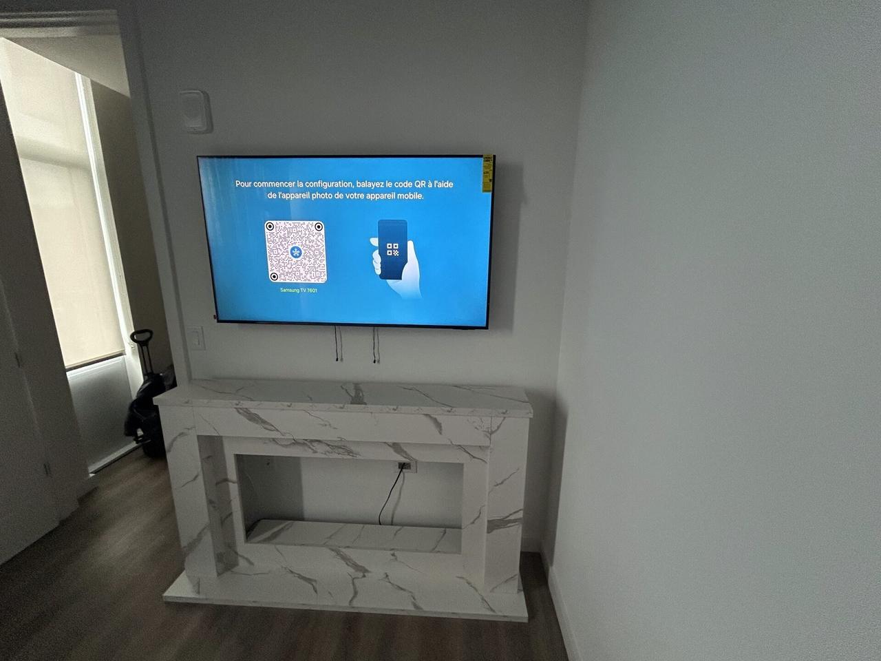 Service documentation showing TV mounting and display setup work with wall hardware context