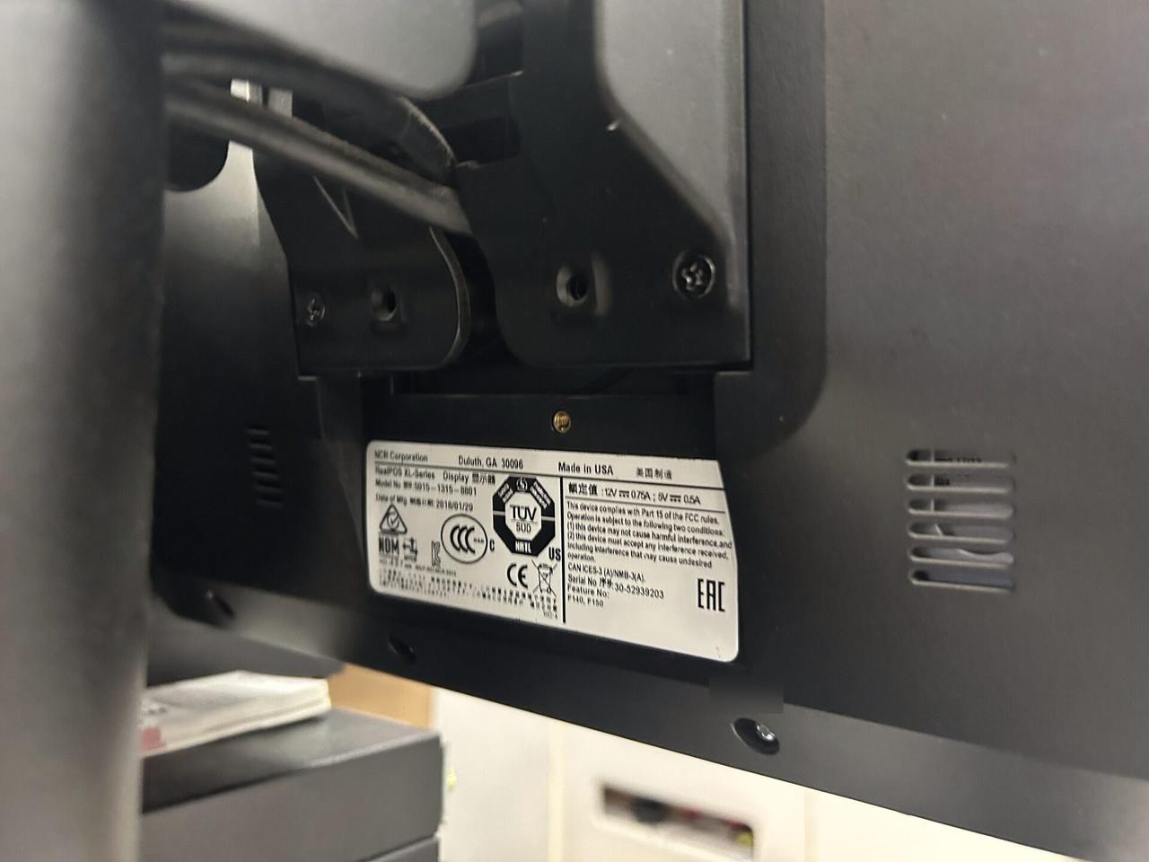 Checkout station POS hardware at the checkout counter during an Alrty onsite service visit
