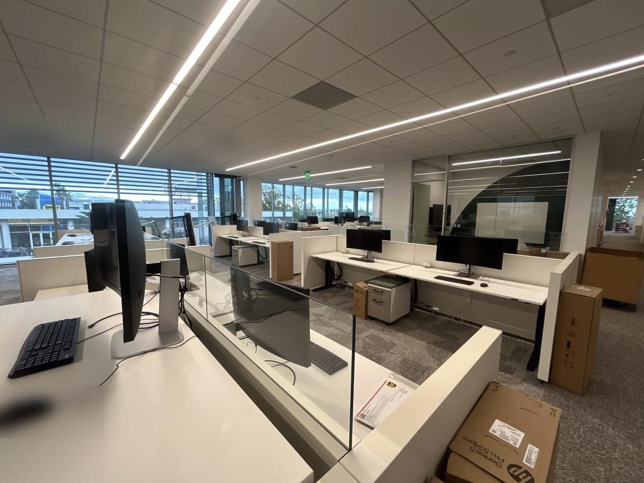 Public-safe portfolio image of business workstation hardware and monitor cabling with peripherals in service context