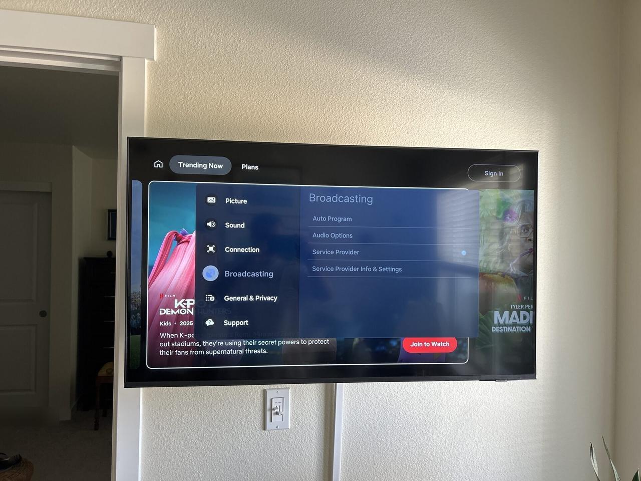 TV mounting or home theater setup detail with display placement, mount work, cabling or finished installation context