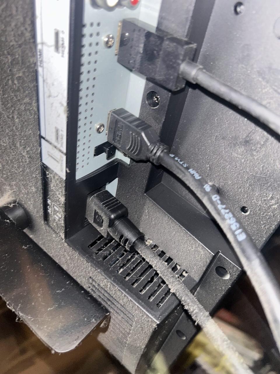 TV mounting or home theater setup detail with display placement, mount work, cabling or finished installation context