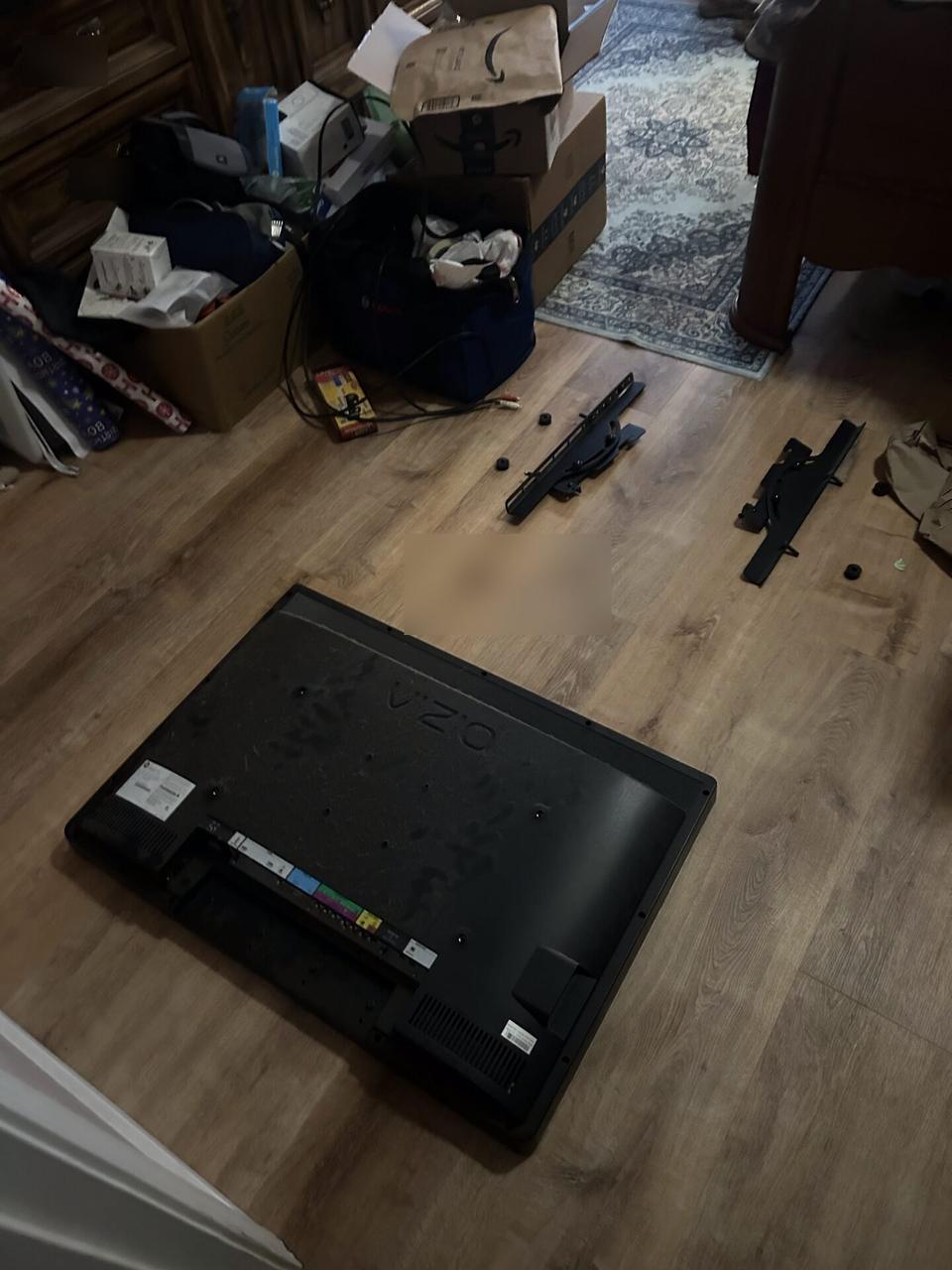 TV mounting and display setup work near the mounting location documented for a smart technology service call