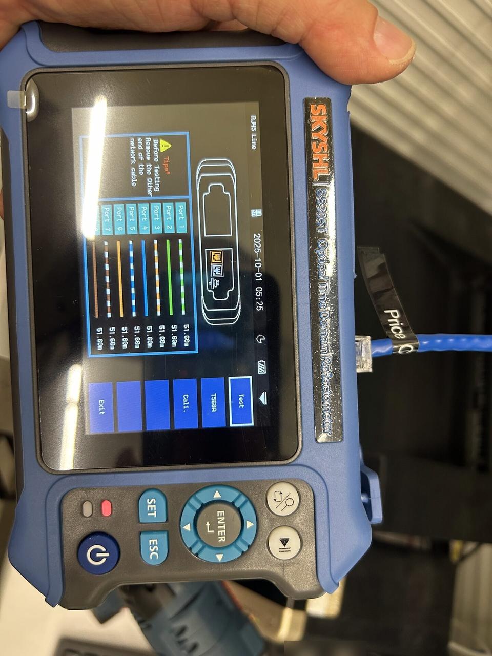 Onsite service photo showing optical and Cat5/Cat6 cable meter measuring distance on wire pairs