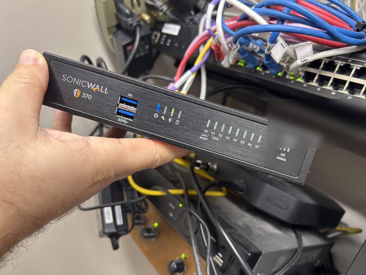 Network rack and patch panel cabling inside the equipment cabinet documented for a smart technology service call