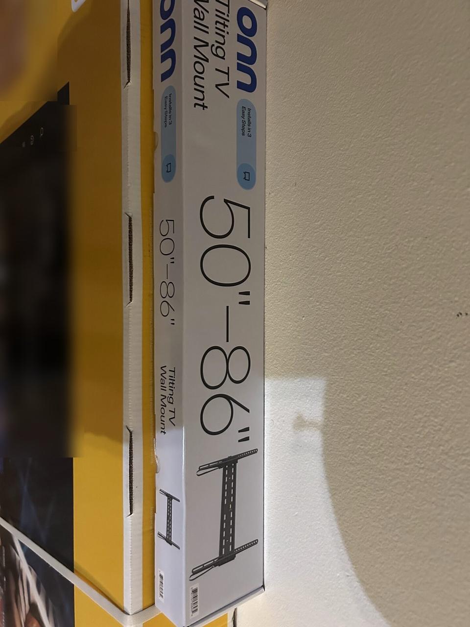 Alrty portfolio view of wall-mounted TV setup and cable routing during TV service preparation