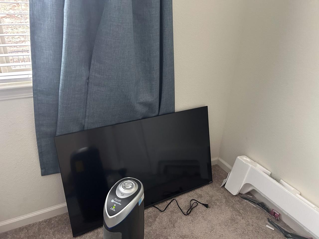 TV mounting or home theater setup detail with display placement, mount work, cabling or finished installation context