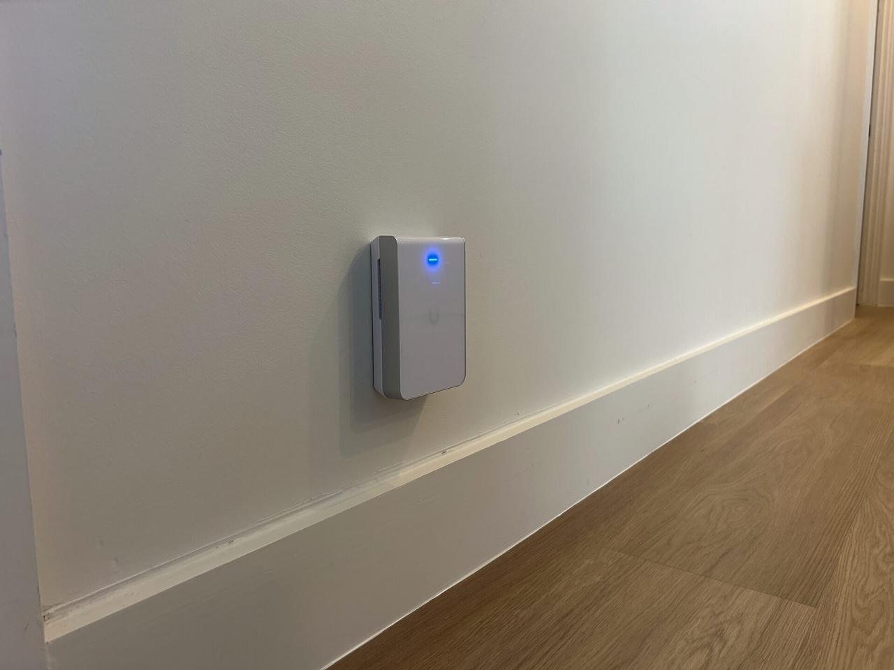 Human-reviewed real photo of a wall-mounted access point for Wi-Fi coverage planning