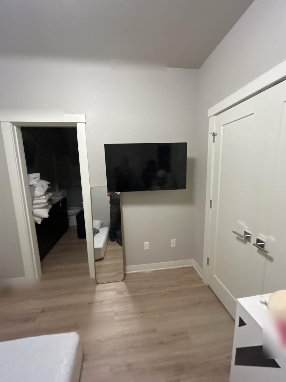 Alrty portfolio view of wall-mounted TV setup and cable routing during TV service preparation