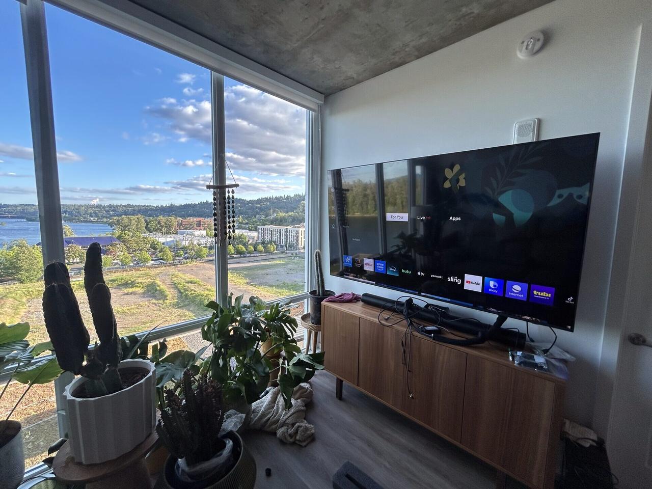 Finished TV mounting installation with screen placed on the wall in a living space